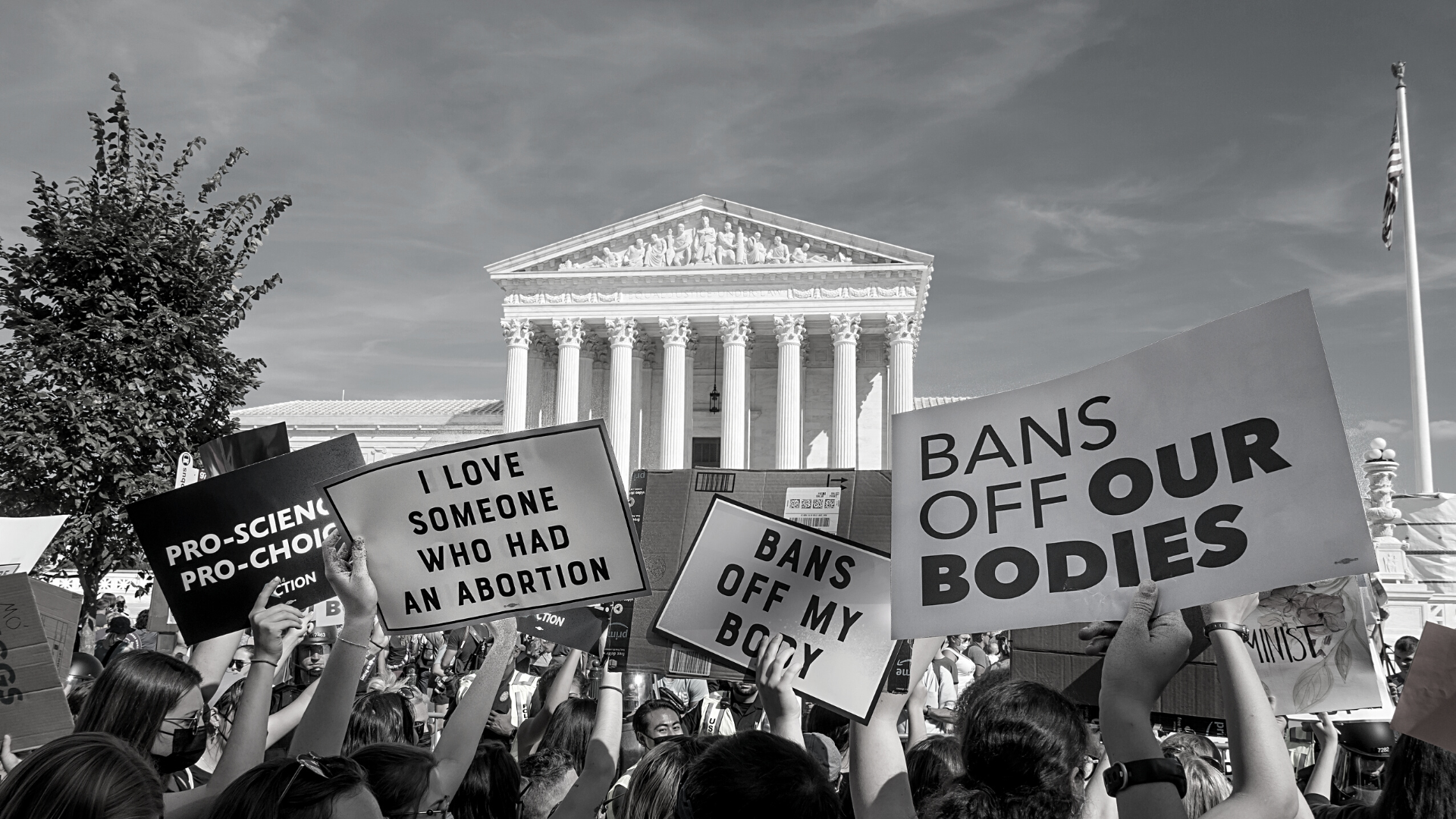 B&W picture of pro-choice protest, people holding signs in front of supreme court