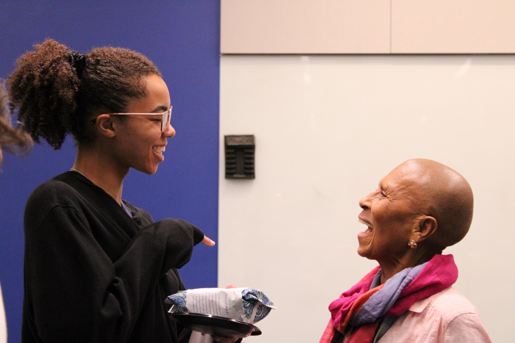 Dr. McFadden is talking with a black woman student after the lecture.