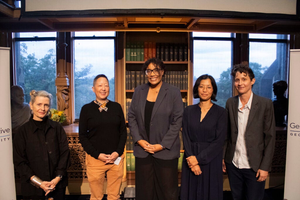 Four panelists and the moderator from the climate justice panel are posing for a photo.