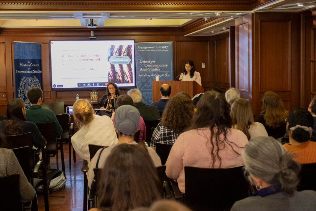 Dr. Shenila Khoja-Moolji, the moderator, is introducing Dr. Fida Adely and her work. 