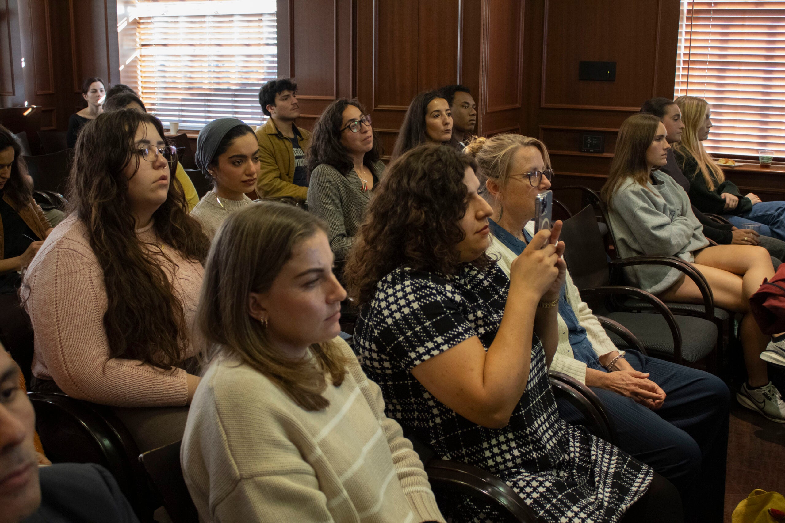 Audience members from the event attentively listen.