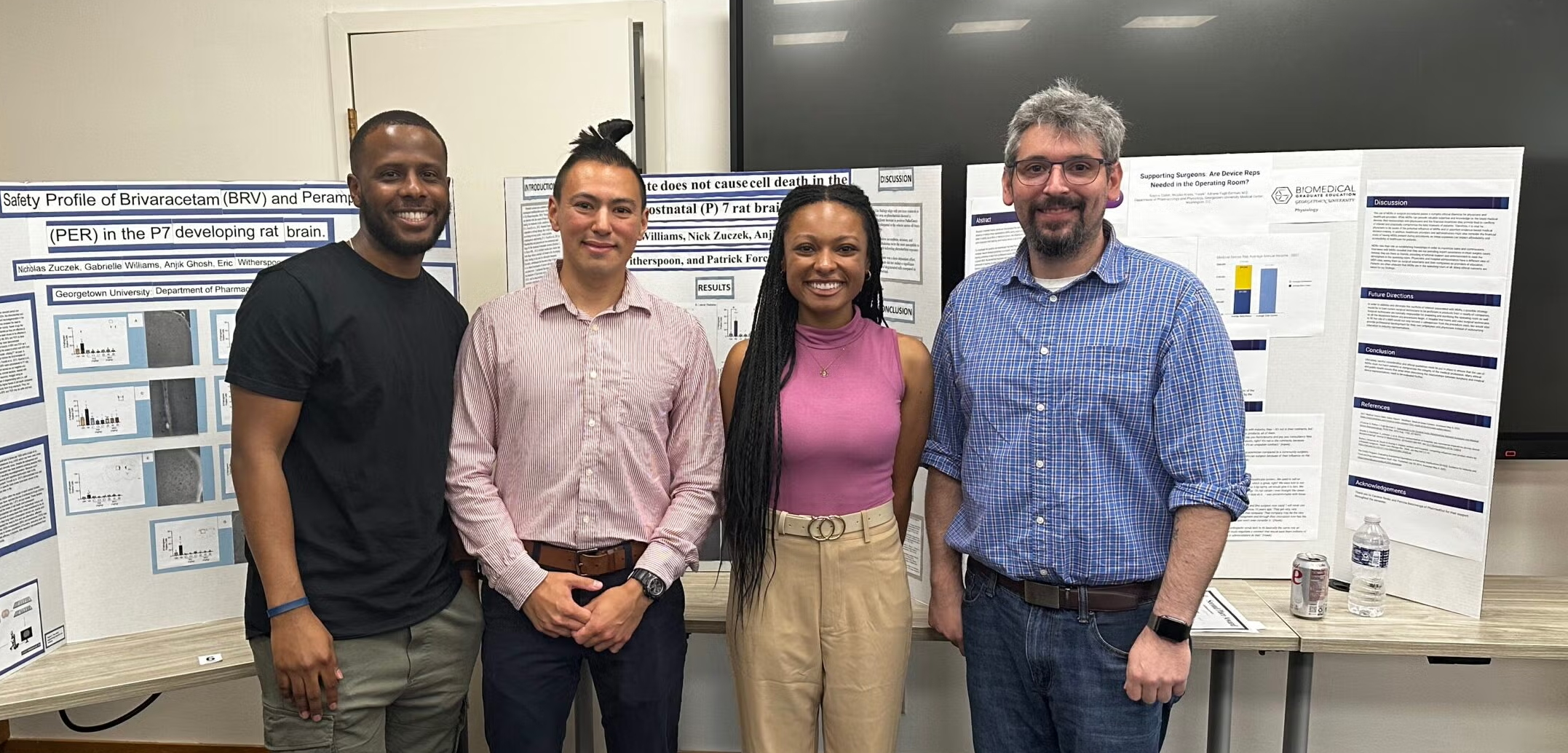 Four people standing in front of Science Posters.