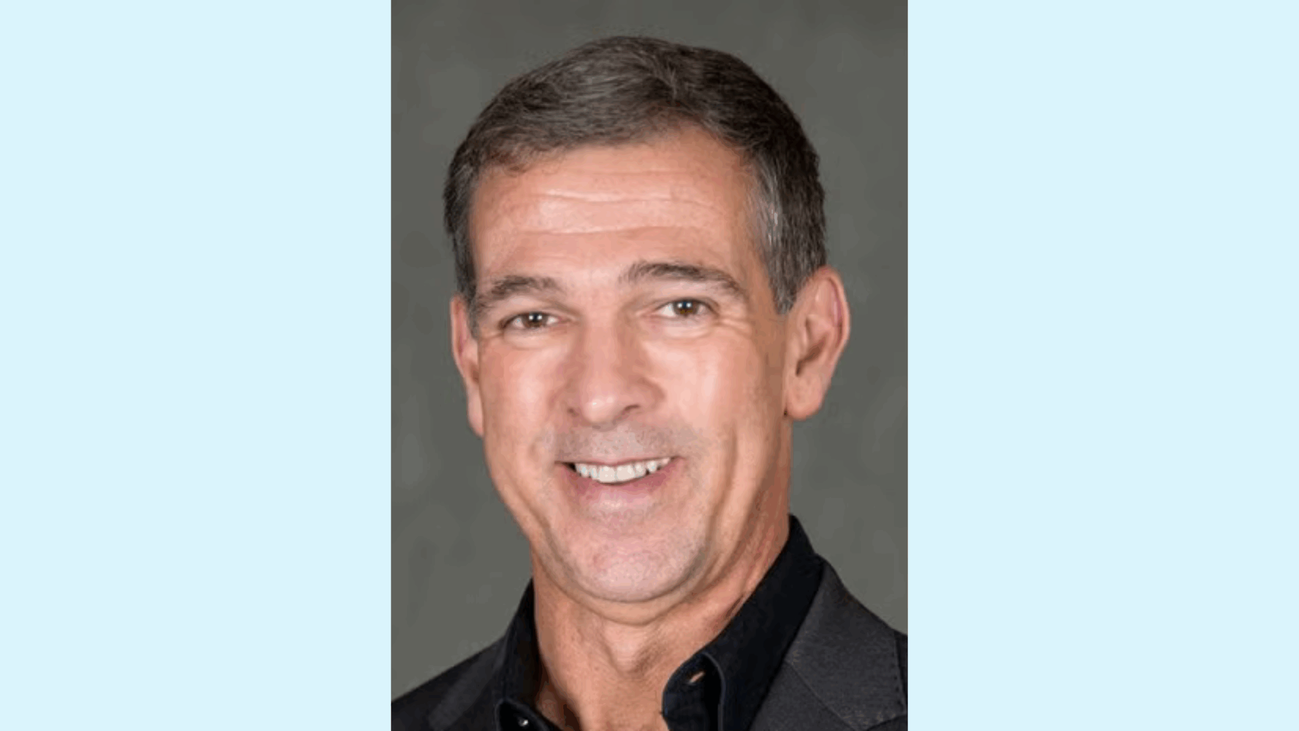 Light blue background. Center: Headshot of Ricardo Ortiz, white man with salt and pepper short hair smiling wearing a black shirt and blazer.