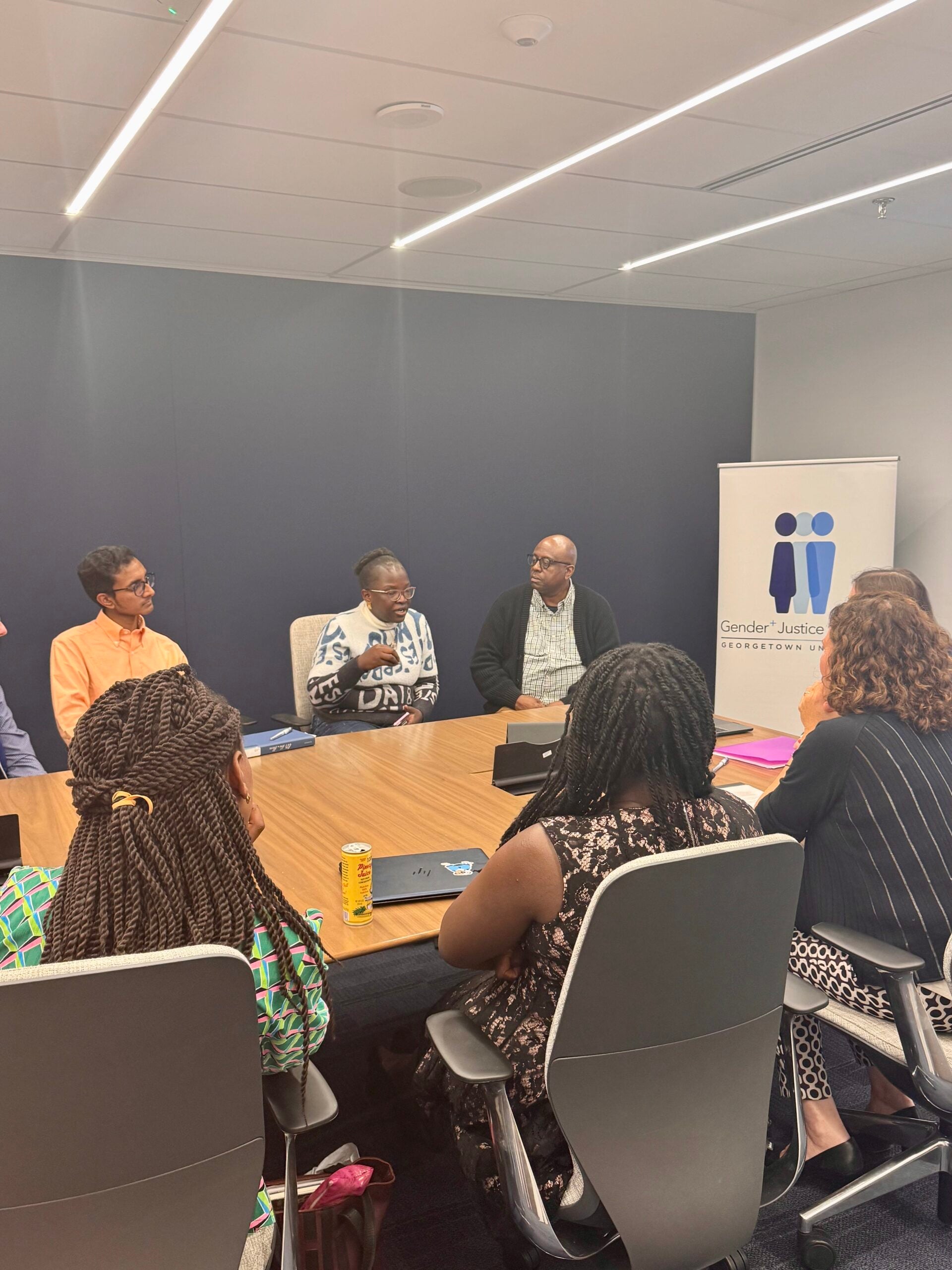A group of people sitting around a conference table.