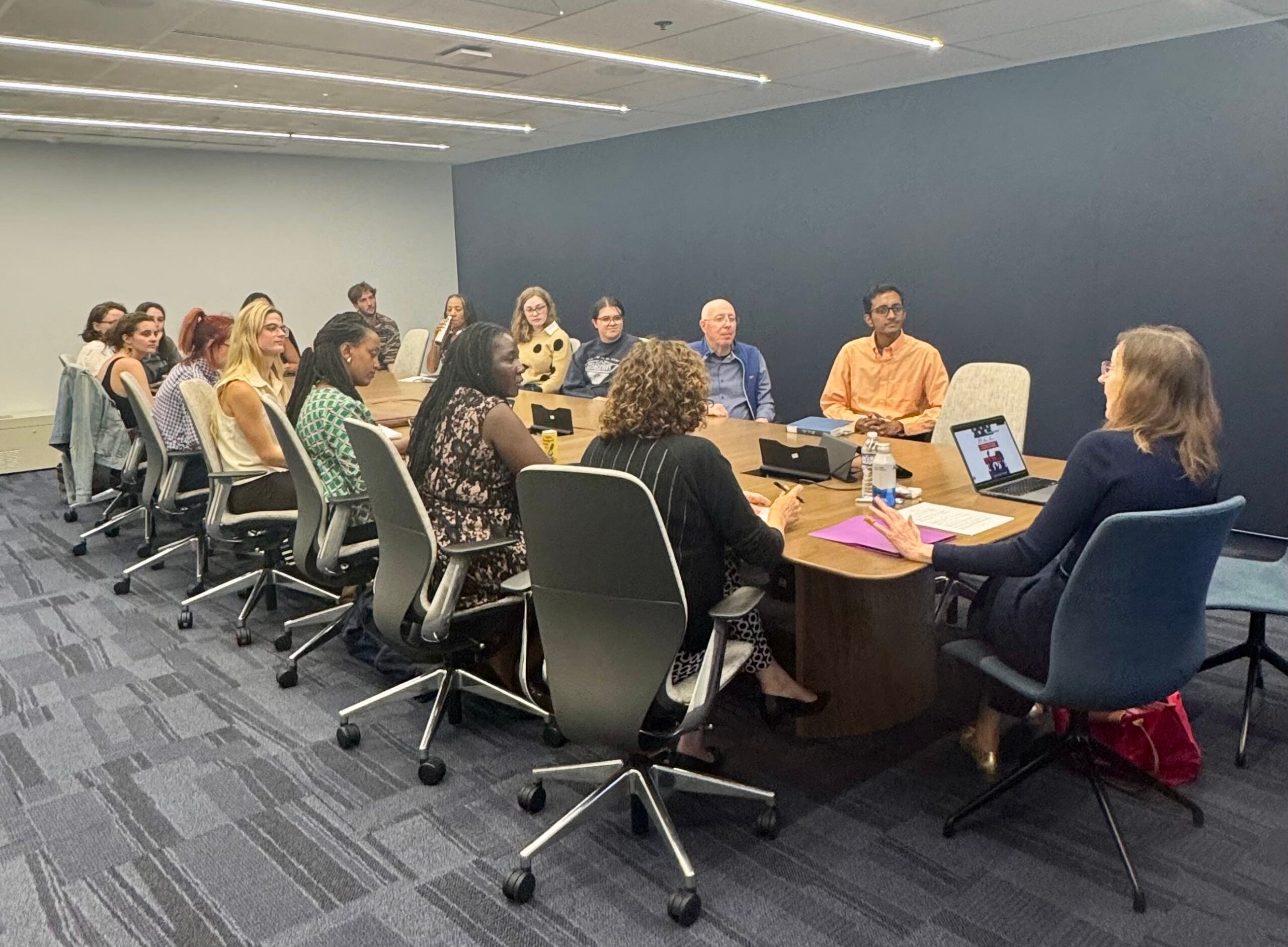 A group of people sitting around a conference table.