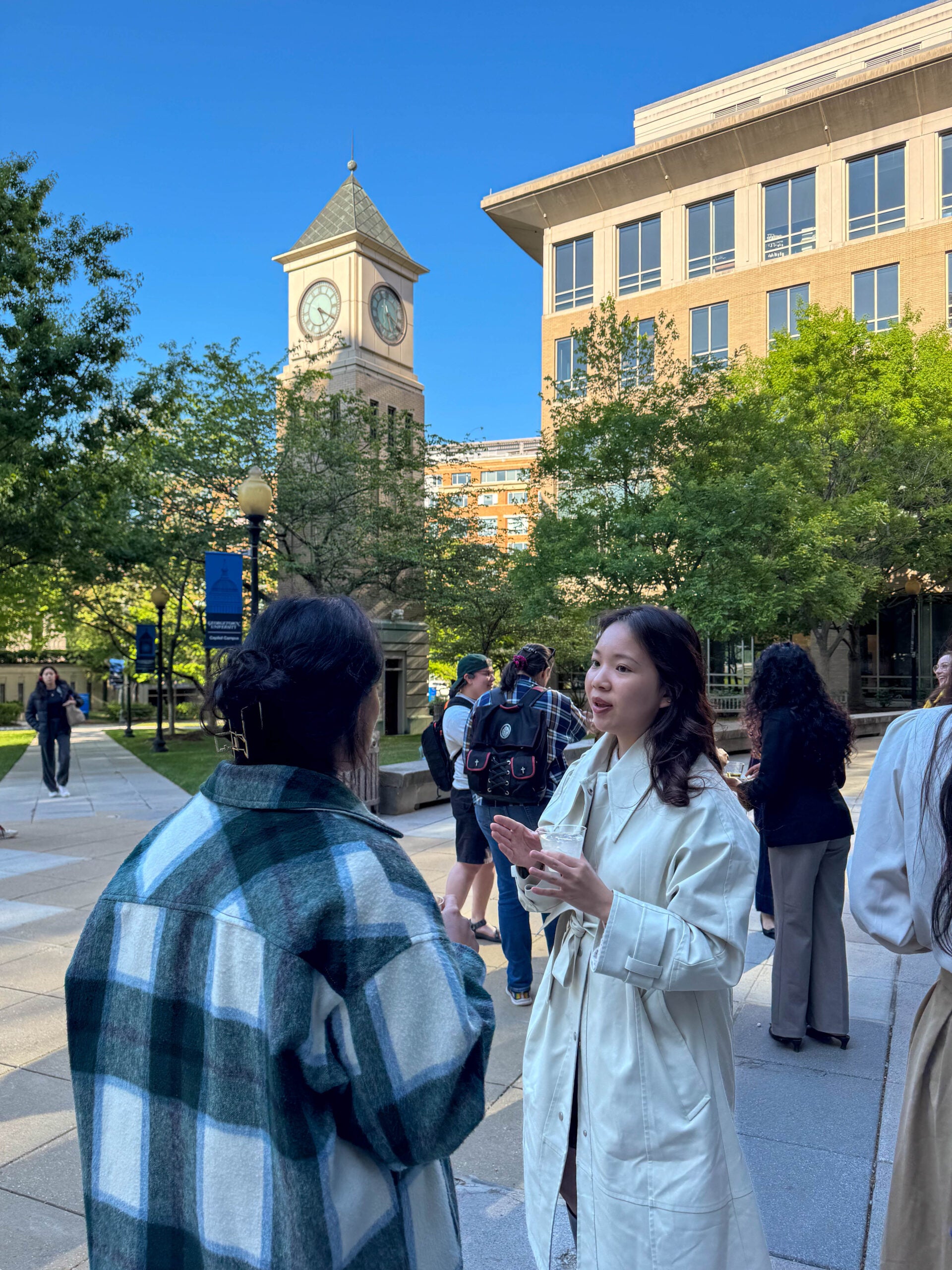 Two women standing outside and talking to each other. 
