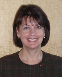A woman with short brown hair cut in a bob, smiling.