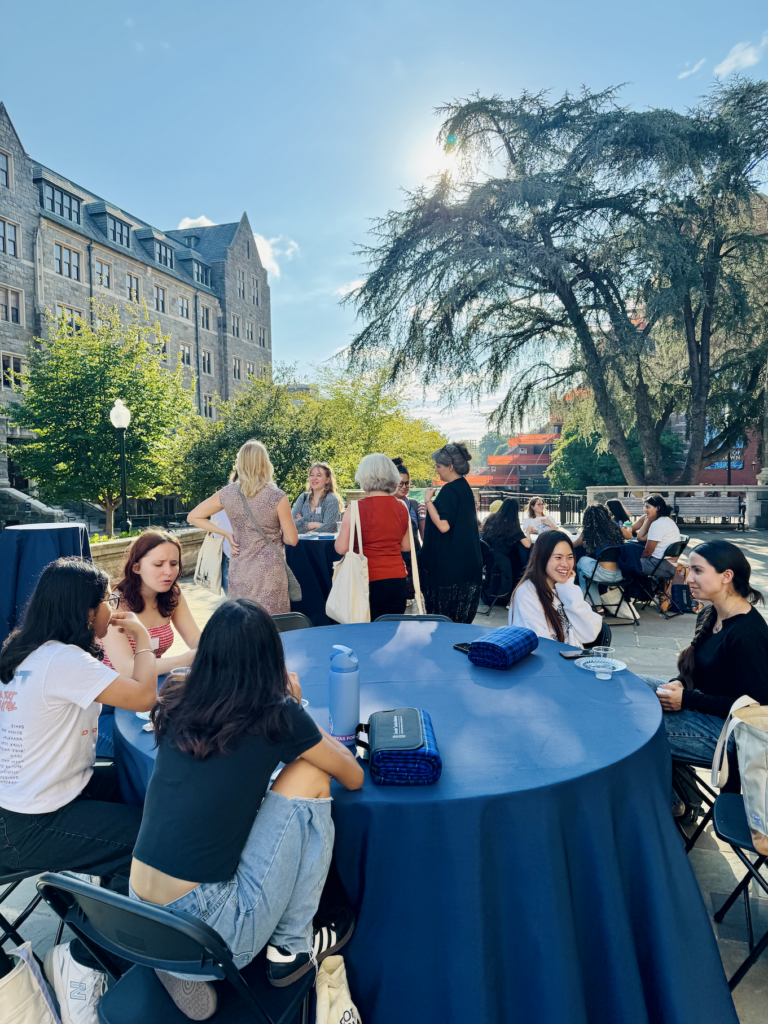 Students, faculty, and staff gather outdoors during G+JI’s Feminist Picnic at Georgetown University.